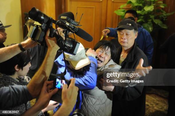 Family member of a passenger from the missing Malaysia Airlines flight MH370 reacts at Lido Hotel on March 24, 2014 in Beijing, China. Malaysian...