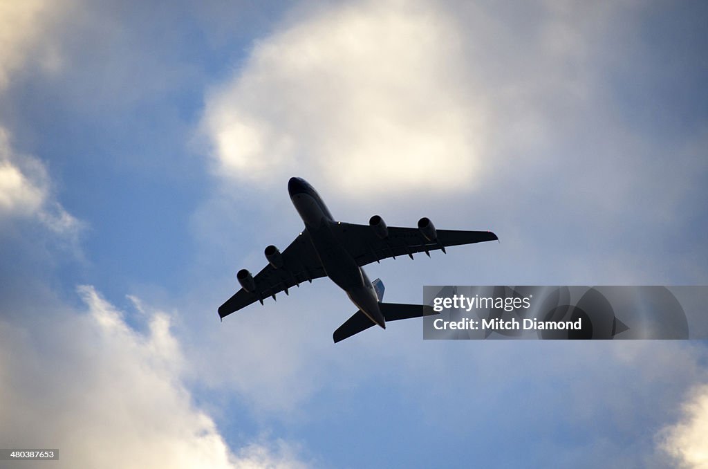 Airplane flying with scattered clouds