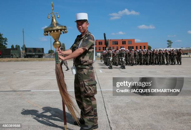 Kuisike, 1st Class Legionnaire of the French Foreign Legion, who carries the "Chinese Hat" , an old Ottoman military band's music instrument that was...