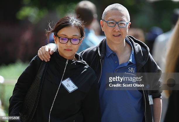 Victor Koo , co-founder of the video website Youku, walks with Helen Quin the Allen & Company Sun Valley Conference on July 11, 2015 in Sun Valley,...