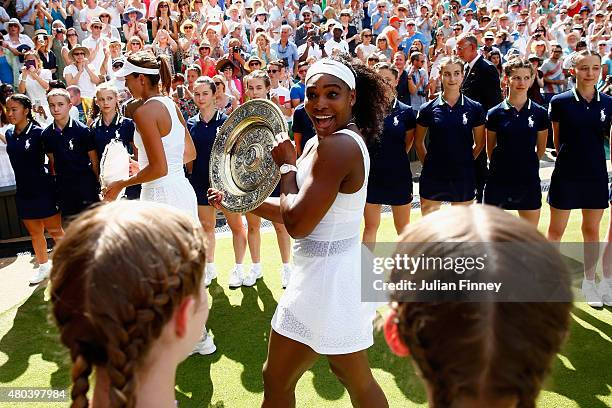 Serena Williams of the United States leaves court with the Venus Rosewater Dish after her victory in the Final Of The Ladies' Singles against Garbine...