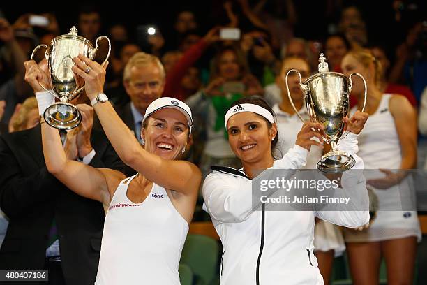 Sania Mirza of India and Martina Hingis of Switzerland celebrate with the trophy after winning the Final Of The Ladies' Doubles against Ekaterina...