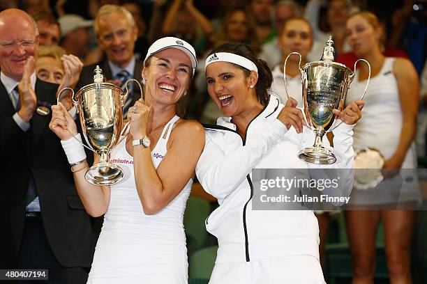 Sania Mirza of India and Martina Hingis of Switzerland celebrate with the trophy after winning the Final Of The Ladies' Doubles against Ekaterina...