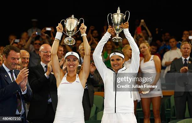 Sania Mirza of India and Martina Hingis of Switzerland celebrate with the trophy after winning the Final Of The Ladies' Doubles against Ekaterina...