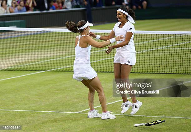 Sania Mirza of India and Martina Hingis of Switzerland celebrate after winning the Final Of The Ladies' Doubles against Ekaterina Makarova of Russia...