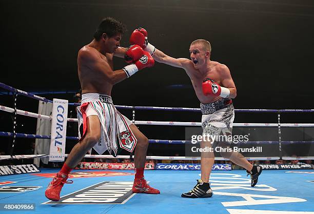 Paul Butler exchanges blows with Gustavo Molina during their super-flyweight contest at the Manchester Velodrome on July 11, 2015 in Manchester,...