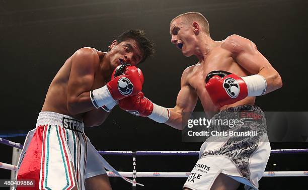 Paul Butler exchanges blows with Gustavo Molina during their super-flyweight contest at the Manchester Velodrome on July 11, 2015 in Manchester,...