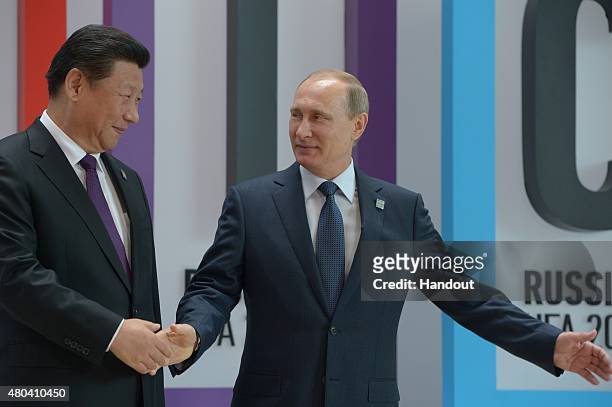 In this handout image supplied by Host Photo Agency / RIA Novosti, President of the Russian Federation Vladimir Putin, right, and President of the...