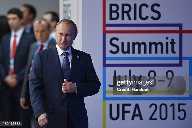 In this handout image supplied by Host Photo Agency / RIA Novosti, President of the Russian Federation Vladimir Putin arrives for a group photograph...