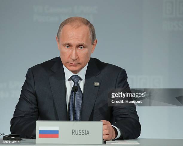 In this handout image supplied by Host Photo Agency / RIA Novosti, President of the Russian Federation Vladimir Putin during the signing of joint...
