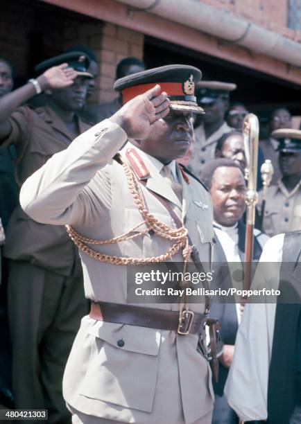 Idi Amin, third president of Uganda, saluting at the state funeral of King Freddie who was its first president and the King of Buganda, circa April...