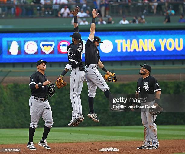 Avisail Garcia and Melky Cabrera of the Chicago White Sox watch as Alexei Ramirez and Adam Eaton leap in celebration after a win over the Chicago...