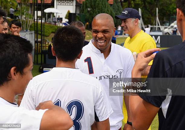 Quinton Fortune talks to young players during the Laureus All Stars Unity Cup ahead of the 2014 Laureus World Sports Awards at Royal Selangor Club on...