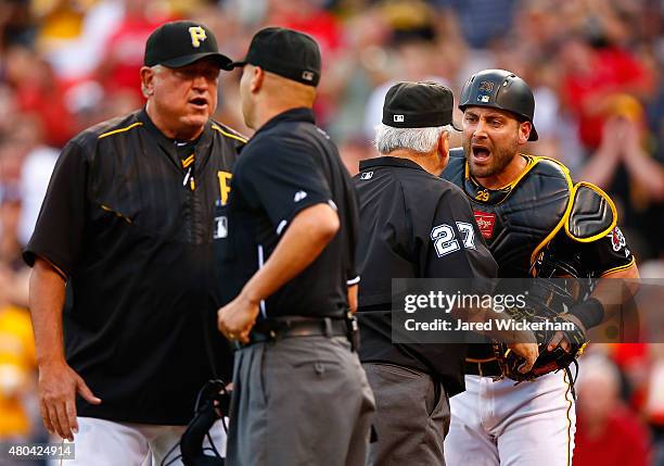 Francisco Cervelli of the Pittsburgh Pirates argues with the umpires after being ejected following a called foul ball that resulted in a home run by...