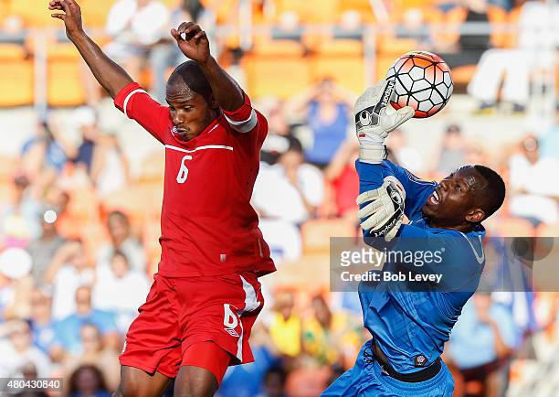 Goalkeeper Dwayne Miller of Jamaica grabs the ball before Julian de Guzman of Canada can get his head on it in the second half at BBVA Compass...