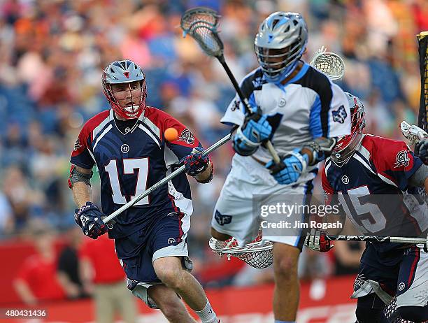 Brodie Merrill of Boston Cannons defends Marcus Holman of Ohio Machine in front of the net in the second half at Gillette Stadium on July 11, 2015 in...