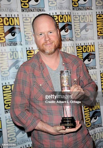 Writer/director Joss Whedon poses with his Comic-Con International Icon Award at Dark Horse: An Interview with Joss Whedon during Comic-Con...