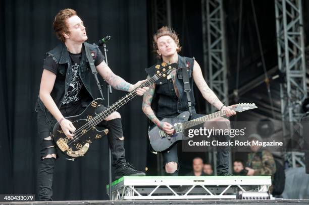 Bassist Sam Bettley and guitarist Ben Bruce of English metalcore group Asking Alexandria performing live on the Main Stage at Download Festival on...