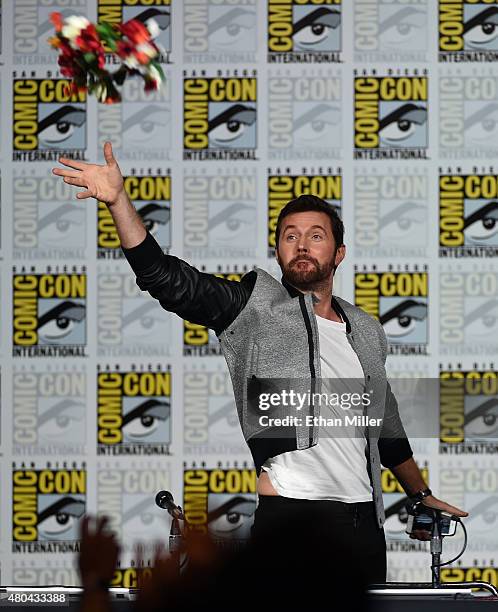 Actor Richard Armitage throws a flower crown to fans at the "Hannibal" Savor the Hunt panel during Comic-Con International 2015 at the San Diego...