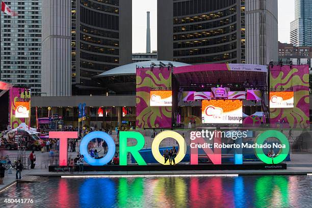 The new Toronto sign in Nathan Phillips Square celebrating the PanAm games, the New City Hall is at the back. A stage have been mounted to held a...