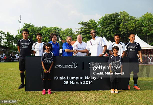 Su Ling, CEO of YR1M, Tan Sri Dato Lodin bin Wok Kamaruddin, Laureus Academy Member Sir Bobby Charlton and Laureus Chairman Edwin Moses pose for an...