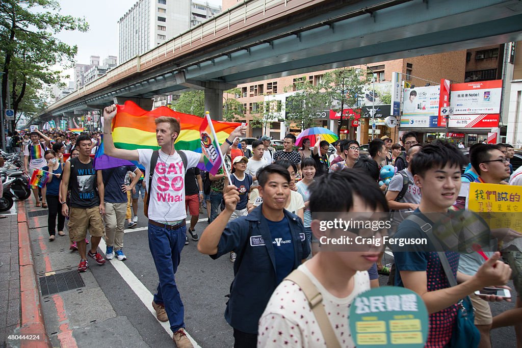 Marchers wave rainbow flags as they proceed through city...