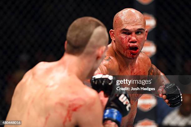 Robbie Lawler punches Rory MacDonald in their UFC welterweight title fight during the UFC 189 event inside MGM Grand Garden Arena on July 11, 2015 in...