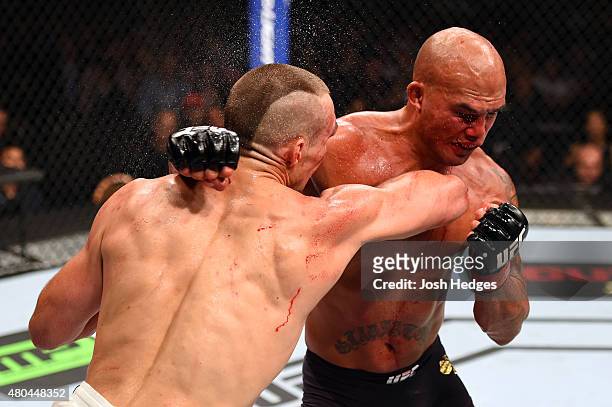 Rory MacDonald and Robbie Lawler exchange punches in their UFC welterweight title fight during the UFC 189 event inside MGM Grand Garden Arena on...