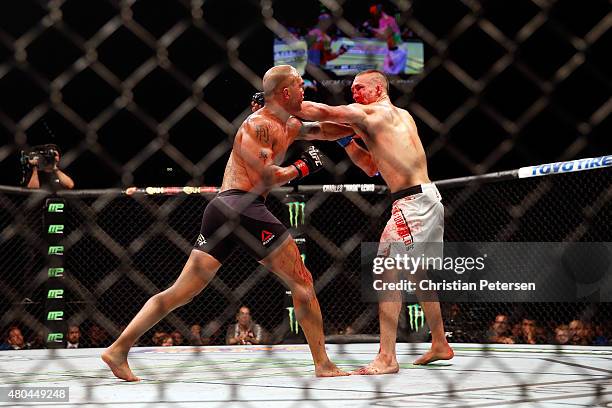 Robbie Lawler punches Rory MacDonald in their UFC welterweight title fight during the UFC 189 event inside MGM Grand Garden Arena on July 11, 2015 in...