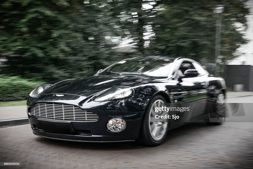 Aston Martin Vanquish sports car driving fast