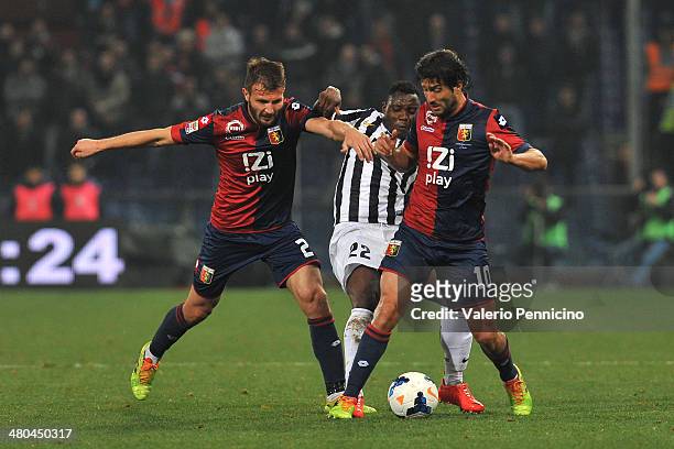Kwadwo Asamoah of Juventus is challenged by Marco Motta and Giuseppe Sculli of Genoa CFC during the Serie A match between Genoa CFC and Juventus at...