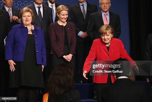 German Chancellor Angela Merkel gestures as Norwegian Prime Minister Erna Solberg and Danish Prime Minister Helle Thorning-Schmidt look on at the...