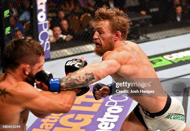 Conor McGregor punches Chad Mendes in their UFC interim featherweight title fight during the UFC 189 event inside MGM Grand Garden Arena on July 11,...