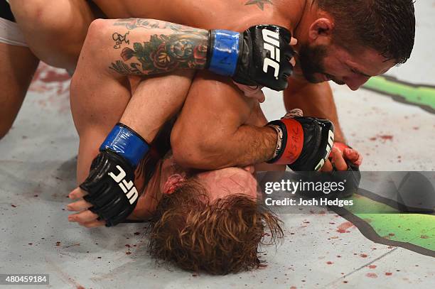 Chad Mendes elbows Conor McGregor in their UFC interim featherweight title fight during the UFC 189 event inside MGM Grand Garden Arena on July 11,...