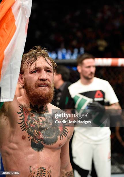 Conor McGregor reacts to his victory over Chad Mendes in their UFC interim featherweight title fight during the UFC 189 event inside MGM Grand Garden...