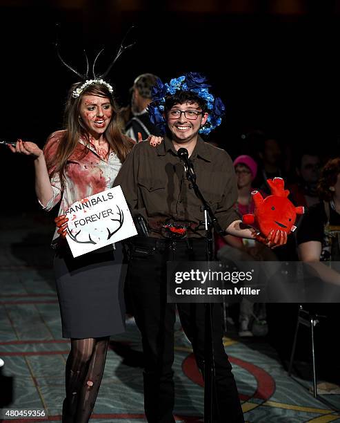 Rotem Rusak of New York and Cassandra Solis of Texas ask the panel a question at the "Hannibal" Savor the Hunt panel during Comic-Con International...