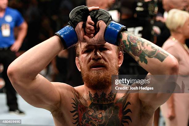 Conor McGregor reacts to his victory over Chad Mendes in their UFC interim featherweight title fight during the UFC 189 event inside MGM Grand Garden...