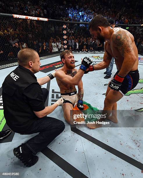 Conor McGregor and Chad Mendes congratulate one another after their UFC interim featherweight title fight during the UFC 189 event inside MGM Grand...