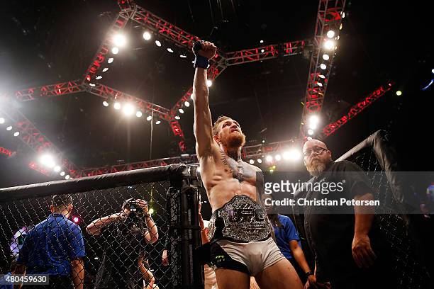 Conor McGregor reacts to his victory over Chad Mendes in their UFC interim featherweight title fight during the UFC 189 event inside MGM Grand Garden...