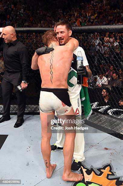 Conor McGregor embraces a temmate after his UFC interim featherweight title fight during the UFC 189 event inside MGM Grand Garden Arena on July 11,...