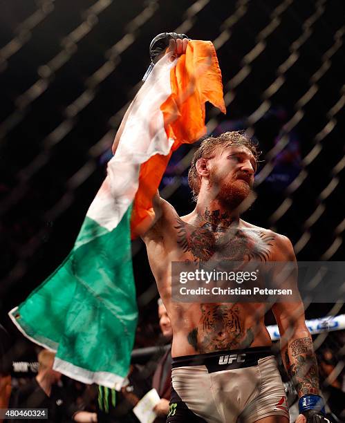 Conor McGregor reacts to his victory over Chad Mendes in their UFC interim featherweight title fight during the UFC 189 event inside MGM Grand Garden...