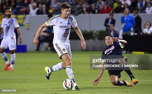 In his MLS debut, Liverpool FC legend Steven Gerrard of the LA Galaxy looks to pass under pressure from Gil Buron of Club America on July 11, 2015...