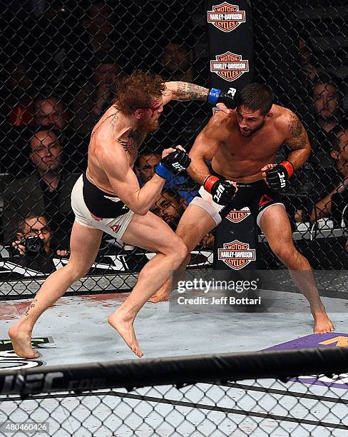 Conor McGregor punches Chad Mendes during the UFC 189 event inside MGM Grand Garden Arena on July 11, 2015 in Las Vegas, Nevada.