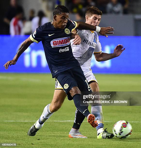 Steven Gerrard of the LA Galaxy vies for the ball with Michael Arroyo of Club America in the ex-Liverpool FC legend's debut for the MLS on July 11,...
