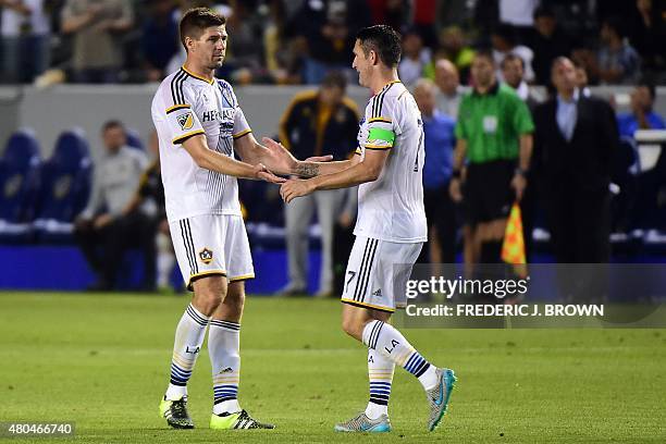 Robbie Keane of the LA Galaxy celebrates with Steven Gerrard after scoring the equalizer against Club America off a pass from Garrard, the...