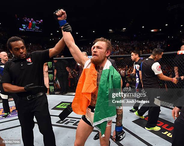 Conor McGregor reacts to his victory over Chad Mendes in their UFC interim featherweight title fight during the UFC 189 event inside MGM Grand Garden...