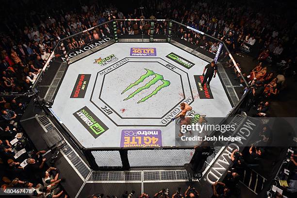 Conor McGregor punches Chad Mendes in their UFC interim featherweight title fight during the UFC 189 event inside MGM Grand Garden Arena on July 11,...