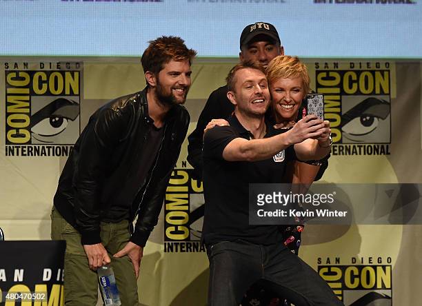 Host Chris Hardwick takes a selfie with actor Adam Scott, actress Toni Colette and director Michael Dougherty speak onstage at the Legendary Pictures...