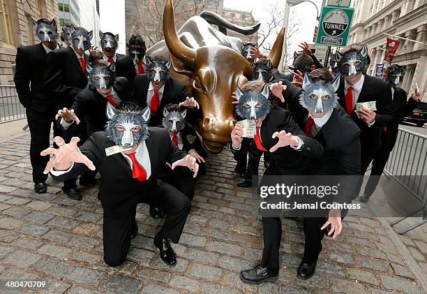 The "Wolves of Wall Street" pose for a photo as they march towards Wall St. To mark the "The Wolf of Wall Street" DVD Release outside of the New York...