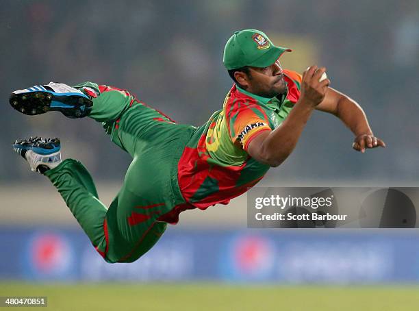 Tamim Iqbal of Bangladesh takes a diving catch to dismiss Dwayne Bravo of the West Indies during the ICC World Twenty20 Bangladesh 2014 match between...